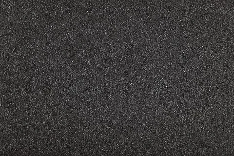 A close-up of a rough black textured surface with fine, intricate details. Ba Stock Photos