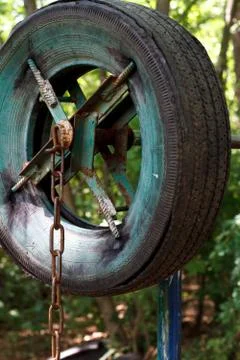 Close-up of a rough home-made simulator from old tires among thick trees in a Stock Photos