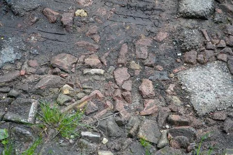 Close up of a rough road made of bricks and rubble 写真素材