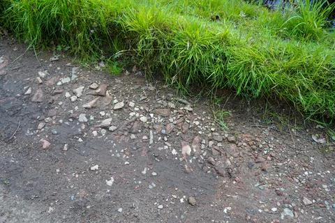 Close up of a rough road made of bricks and rubble Stock Photos