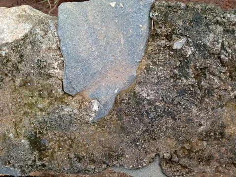 Close up of rough weathered stone surface with gray and brown rock layers, .. 写真素材