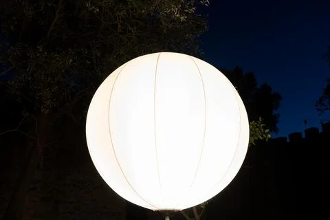 Close up of round bright light shade lighted up in the darkness Stock Photos