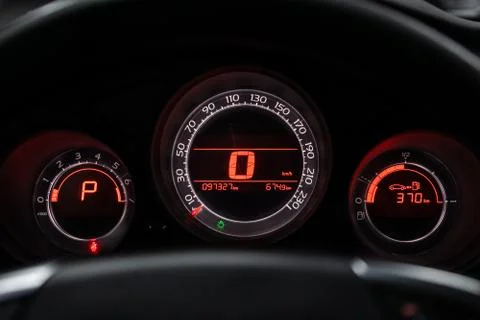 Close-up of round dashboard, speedometer and tachometer with white backlight. 스톡 사진