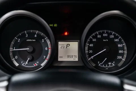 Close-up of round dashboard, speedometer and tachometer with white backlight. 스톡 사진