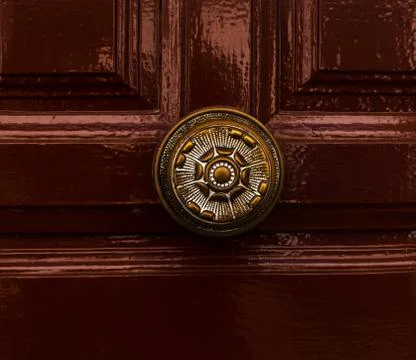 Close up on a round door handle with decorative elements, door decoration Stock Photos