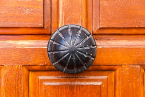Close up on a round door handle with decorative elements, door decoration Stock Photos