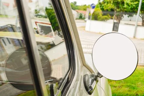 Close-up of a round mirror in a silver retro car with a place for a signature on Foto stock