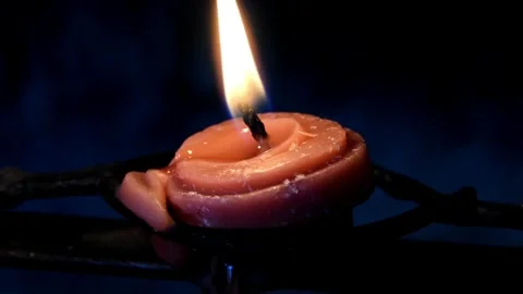 Close up of a round thin candle with moving flame Stock Footage 248347764