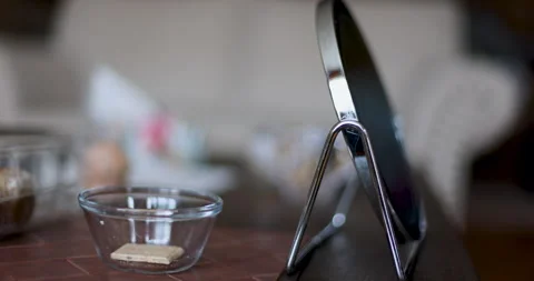Close-up of a Round Vanity Mirror and Small Glass Bowl on a Table 4K Video stock 329326181