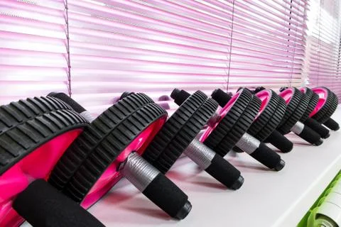 Close-up of a row of AB wheels on a light background on the shelf of a fitness Stock Photos