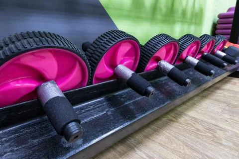 Close-up of a row of AB wheels on a light background on the shelf of a fitness Stock Photos