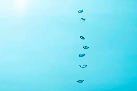 Close up to row of  air bubble , isolated on blue background. Stock Photos