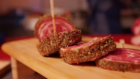 Close up of row beef roulade cuts with skewers on a wooden cutting board. Stock Footage 295262216