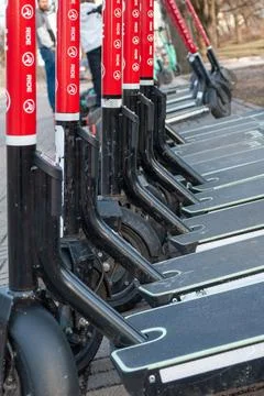 Close up row of electric scooters, shared transport detail Stock Photos