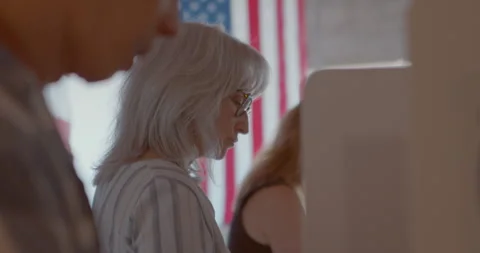 Close up on a row of focused voters casting their votes Stock Footage 274920532