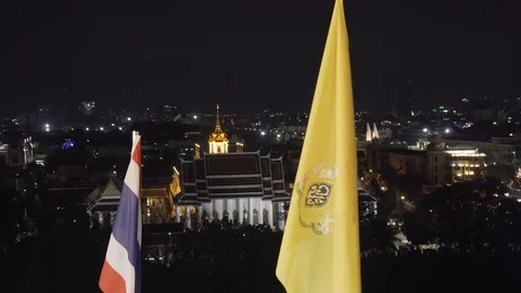 Close up row off illuminated, colourful flags  city skyline of Bangkok at night. Stock Footage 108500731