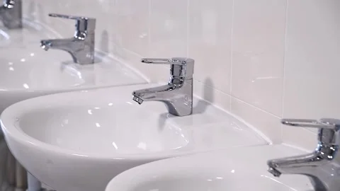 Close-up of row modern ceramic wash hand basins Stock Footage 255444888