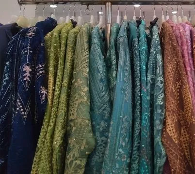 Close up, row of multi color display female Brocade dress for sell at Fashi.. Stock Photos