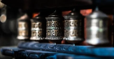 Close-up row of prayer wheels Stock Photos