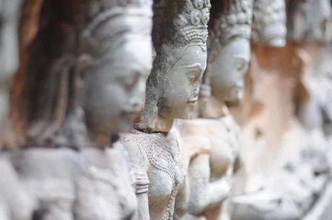 Close up of Row of Statues along a wall in asian temple, Cambodia Stock Photos