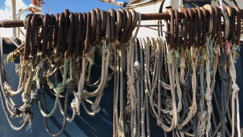 CLOSE UP Row of Weathered Ropes and Fishing Equipment on Old Long Line Trawler Stock Footage