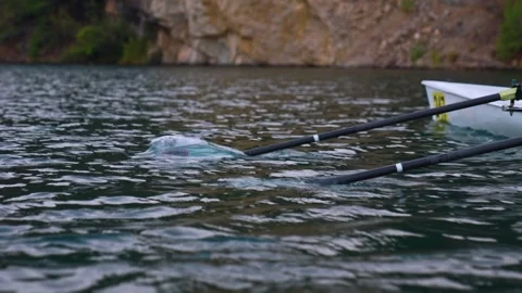 Close-Up of Rowing Oars Moving Through Lake Water Stock Footage 335387870