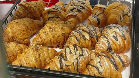 Close up of rows Assorted gourmet croissants on tray in bakery cafe. Fresh Stock Footage 343042680