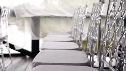 Close-up of rows of chairs with transparent backs at a wedding ceremony. Stock Footage 334941516