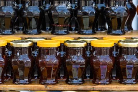 Close up of rows of jars with jam in display at a street food market Stock Photos