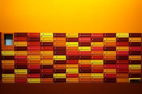 Close up of rows of multicolored mailboxes with numbers of flats 스톡 사진