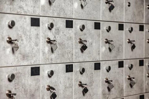 Close-up of rows of numbered grey mailbox with keys in modern design build Stock-Fotos