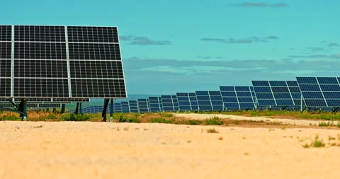 Close-up, rows of solar panels are installed in a field. Solar panels produce Stock Footage 139116489