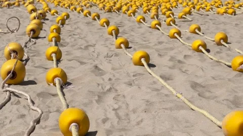 Close up Rows of Yellow Buoys on braided rope neatly laid out in parallel and Vídeos de archivo 339638884