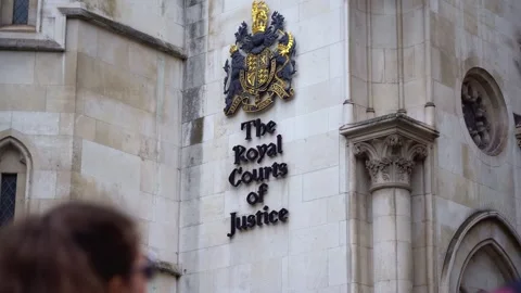 Close-Up of Royal Courts of Justice Crest with Pedestrians, London Stock Footage 286134685
