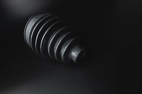 Close-up of a rubber boot on a CV joint on a black background in selective focus Stock Photos