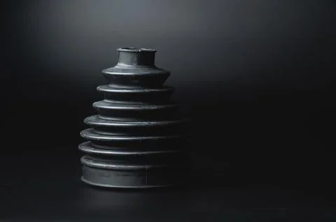 Close-up of a rubber boot on a CV joint on a black background in selective focus Stock Photos