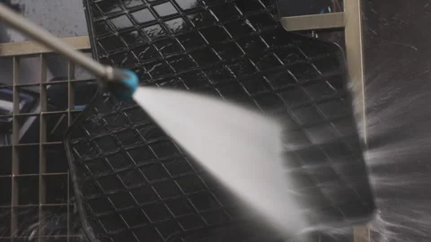 Close-up of rubber car floor mat being cleaned with a high-pressure water spray Stock-Footage 287227417