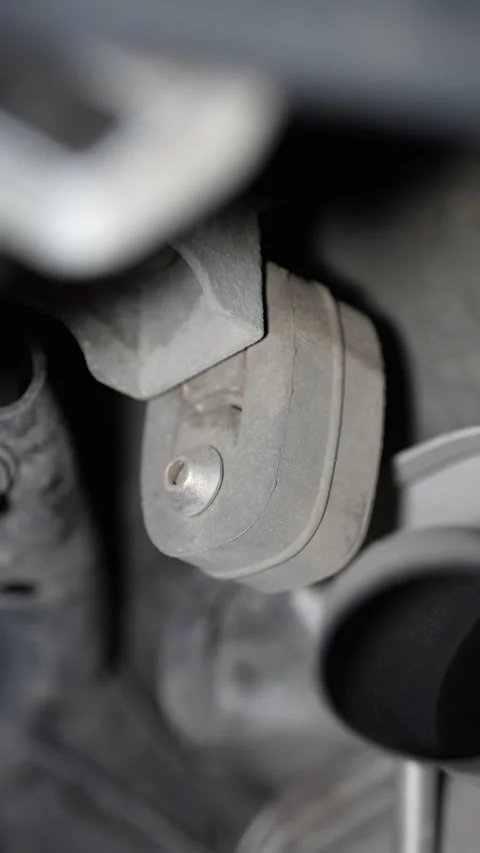Close-up of a rubber exhaust hanger mount under a car. Stock Footage 345707470