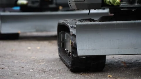 Close up of rubber track on modern construction machinery moving on asphalt s Stock Footage 320803965