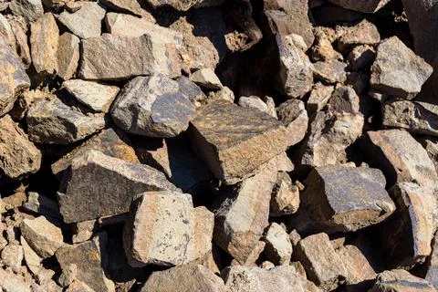 Close up of rubble pile with angular stones and rough texture under bright Stock Photos