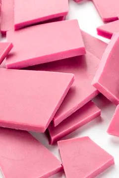 A close-up of ruby chocolate slices, a heap on a white background 스톡 사진