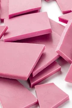 A close-up of ruby chocolate slices, a heap on a white background 写真素材