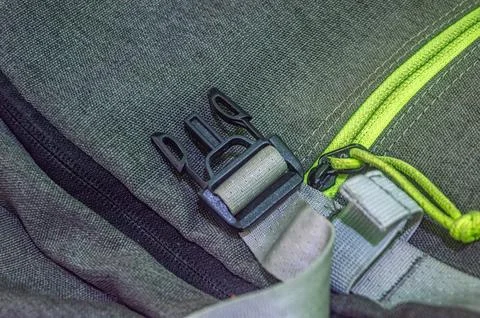Close up of a rugged backpack featuring a green zipper and sturdy buckle, h.. 스톡 사진