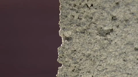 Close-up of a rugged concrete wall surface with details visible Stock Footage 320638675