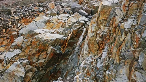 Close-up of rugged rock face with orange and grey texture at Glacier Basin Trail Video stock 332141971
