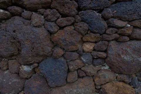 A close-up of a rugged stone wall Stock Photos