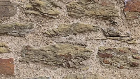 Close-up of a rugged stone wall texture featuring rough natural blocks and .. Stock Footage 346654297