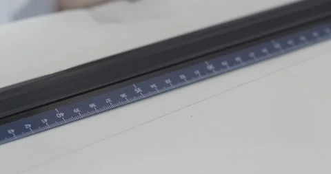 Close-up of ruler: the man bends over the desk and makes notes with a pen, Stock Footage 130470595