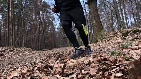 Close up of a runner feet running on forrest road. Stock Footage 73963653