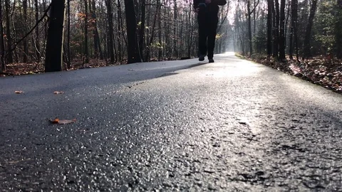 Close up of a runner feet running on park alley Stock Footage 82682219
